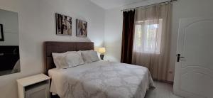 a bedroom with a bed and a window at Apartments 101 in Kotor
