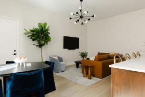 a living room with a couch and a table at The Purple Martin - Nest in Louisville