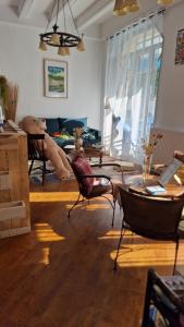a living room with a teddy bear sitting in chairs at Hotel ChezJeanne in La Bourboule