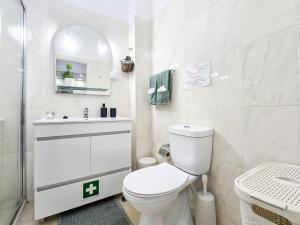 a white bathroom with a toilet and a sink at Apartment Panorama Green in Portimão +19 photos