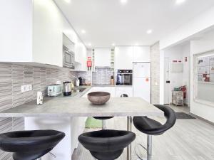 a kitchen with a table and two black chairs at Apartment Panorama Green in Portimão