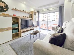 a living room with a couch and a tv at Apartment Panorama Green in Portimão