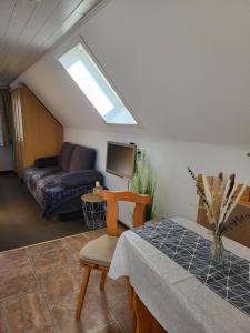 a living room with a couch and a table at Kleiner Leuchtturm Kühlungsborn in Kühlungsborn