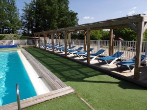 a swimming pool with lounge chairs and a gazebo at OPHEA 4 personnes in Limeuil