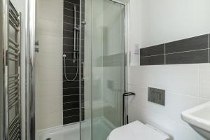 a bathroom with a shower and a toilet and a sink at Central comfort and explore nearby cafes in Aberdeen