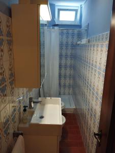 a bathroom with a sink and a toilet and a window at Casetta Nel Borgo in Sestri Levante +7 photos