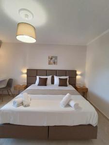 A bed or beds in a room at Roussa's Apartments