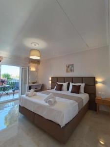 A bed or beds in a room at Roussa's Apartments