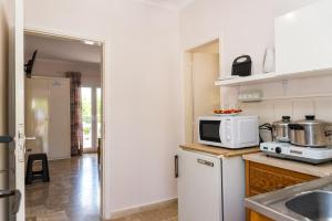 A kitchen or kitchenette at Roussa's Apartments