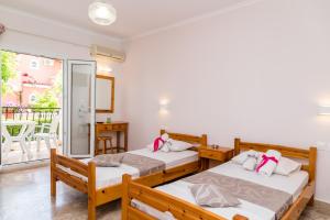 A bed or beds in a room at Roussa's Apartments