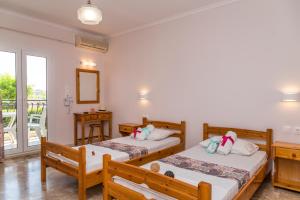 A bed or beds in a room at Roussa's Apartments