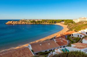 a view of a beach with buildings and the ocean at Costa Arenal 81 in Arenal d'en Castell