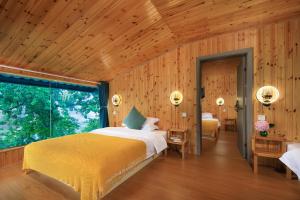 Postel nebo postele na pokoji v ubytování Longji Aplo Leisure B&B
