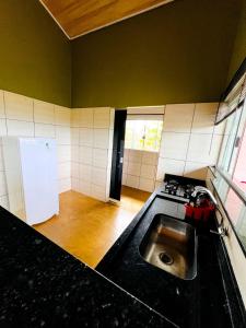 a kitchen with a sink and a stove at Casa do Chagas in Sao Jorge