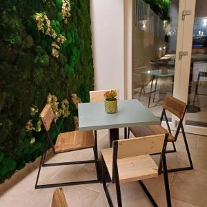 a table and two chairs and a plant at Amarena Garden House in Matera