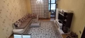 a living room with a couch and a table at Apartament in Mekhrably
