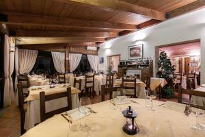 a restaurant with white tables and chairs and a christmas tree at Il Conte Matto in Trequanda