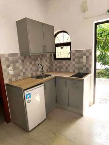 a kitchen with a sink and a counter top at Fontana 1-Bedroom House in Kavos