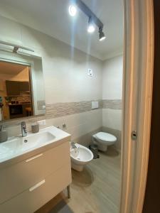a bathroom with a sink and a toilet and a mirror at Casa Angelina in Molfetta +11 photos