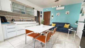 a kitchen and living room with a table and chairs at Light Blue House in Montesilvano
