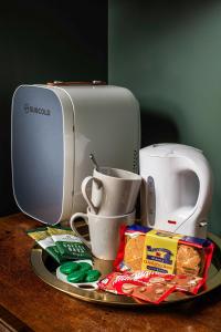 a plate with a coffee maker and a coffee pot and aounter at Riversdale House Bed & Breakfast in Llangollen