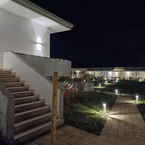 a set of stairs leading to a house at night at Amarena Garden House in Matera