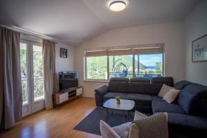 a living room with a couch and a table at Apartment Fortuna in Trpanj