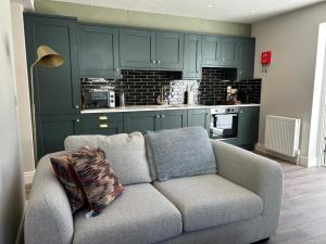 ベルファストにあるFisherwick House Apartmentsのソファとキッチンのあるリビングルーム