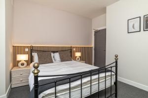 a bedroom with a bed and two lamps on a nightstand at * Ground Floor * The Grove * in Aberdeen