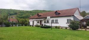 a white house with a soccer ball in a yard at La Florina in Şuncuiuş