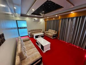 a waiting room with couches and a table in a room at Hotel Al-Hayat Abasik in Dhaka