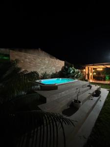 a swimming pool in a yard at night at Gbsitio in Brasília