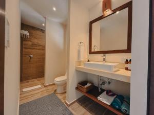 a bathroom with a sink and a toilet and a mirror at Casa Altamar in Tulum +79 photos