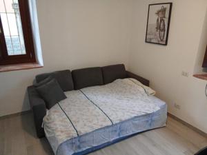 a bedroom with a bed in a room with a window at Venturelli's Home in Barzanò