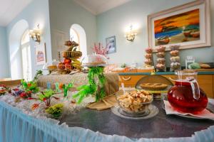 a table with food on it in a room at Hotel Rivamare in Ischia