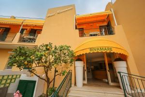 an entrance to an apartment building with an orange at Hotel Rivamare in Ischia