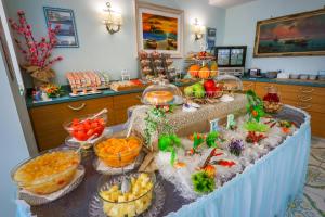 a buffet with fruits and vegetables on a table at Hotel Rivamare in Ischia