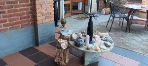 a patio with a table and chairs and a brick wall at Marciloui in Antsirabe