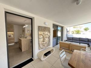 a living room with a couch and a table at Valras-Loc Archipel Panarea Spa confort in Valras-Plage
