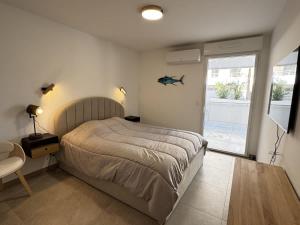 a bedroom with a bed and a large window at Valras-Loc Archipel Panarea Spa confort in Valras-Plage +10 photos