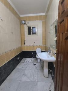 a bathroom with a sink and a toilet at اجنحة الشام بلس in Al Madinah