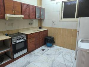a kitchen with a stove and a sink in it at اجنحة الشام بلس in Al Madinah