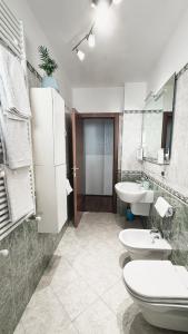 a bathroom with a sink and a toilet and a sink at Light Blue House in Montesilvano +18 photos