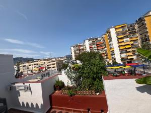 a view of a city from a balcony with buildings at Habitación con baño privado in Mijas