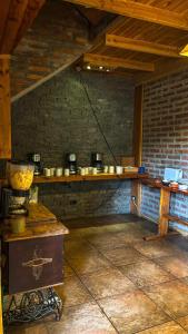 a kitchen with a counter and a brick wall at Periko´s Youth Hostel in San Carlos de Bariloche