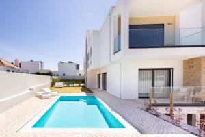 a swimming pool in the backyard of a house at Encanto da Foz - BY SCH in Foz do Arelho