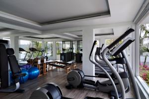 a gym with treadmills and exercise equipment in a room at The Nai Harn in Nai Harn Beach