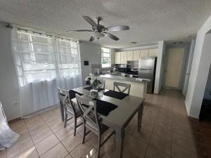 伊莎贝拉Large 1 Bedroom Apt with 2 balconies and Pool的厨房配有桌椅和吊扇。