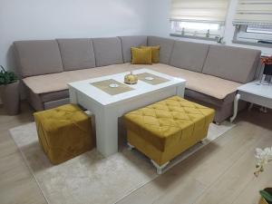 a living room with a couch and a table at Stan na dan Srebrenik in Srebrenik