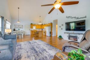 a living room with a couch and a ceiling fan at 3 Mi to Hiawassee Berry Cute Country Cottage in Hiawassee